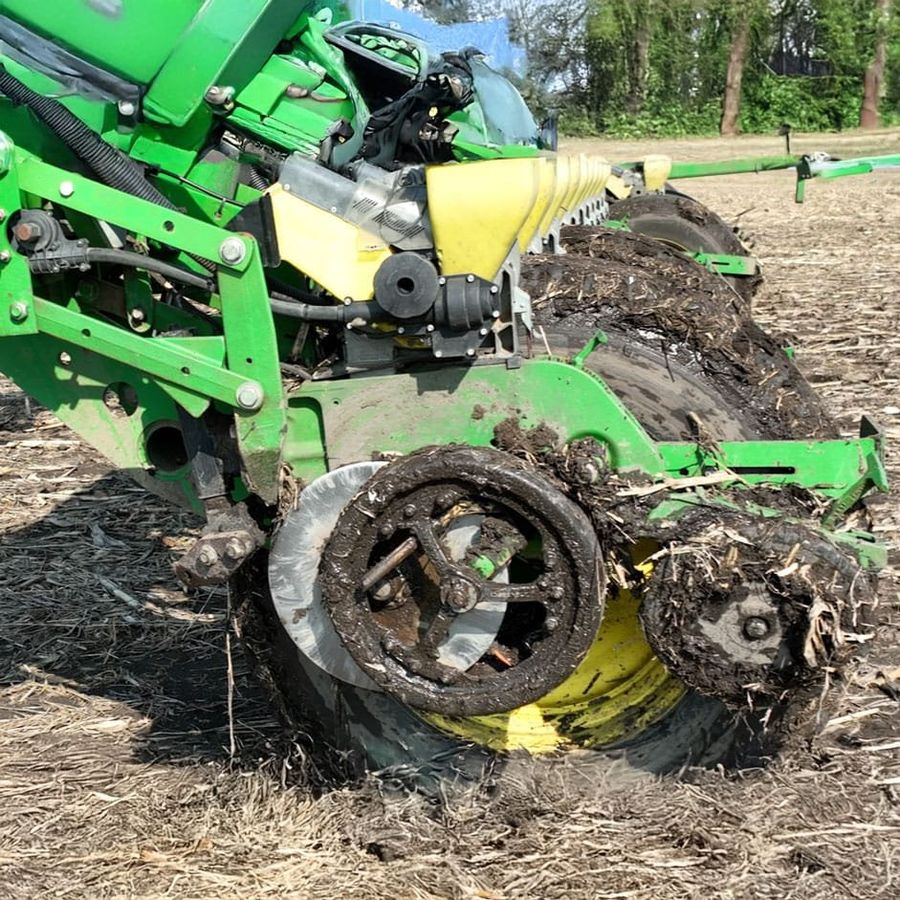 A planter gauge wheel fitted with the steel ring, working in wet spring soil