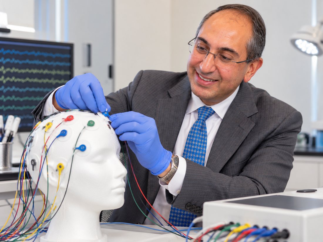 EEG electrodes being placed on a training manikin head.