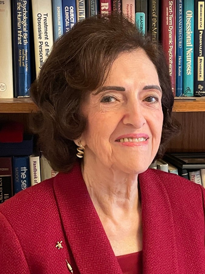 Ana Eugenia Ferreira, PhD, photographed in front of her psychoanalytic library