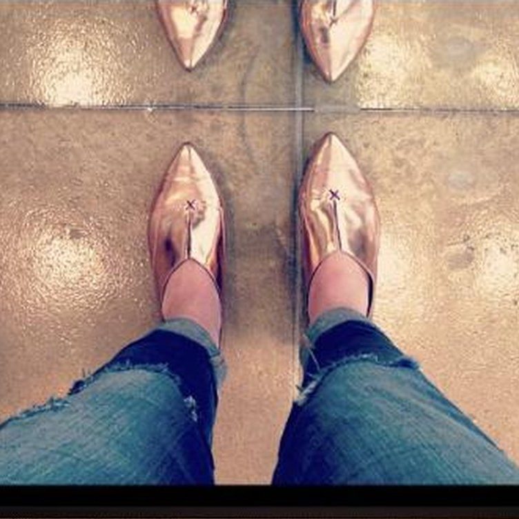 Rose gold pointed flats, worn