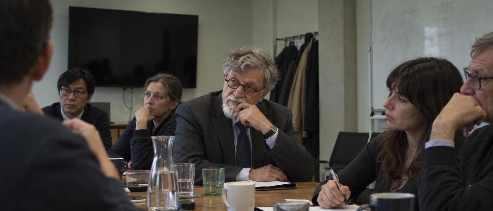 Illustrative portrait of Ronald Berenbeim in a meeting room