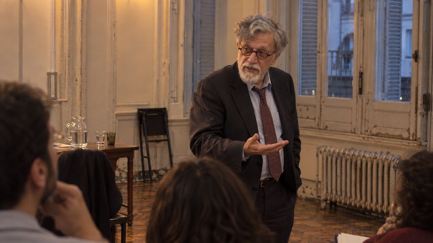 Illustrative portrait of Ronald Berenbeim addressing a small group